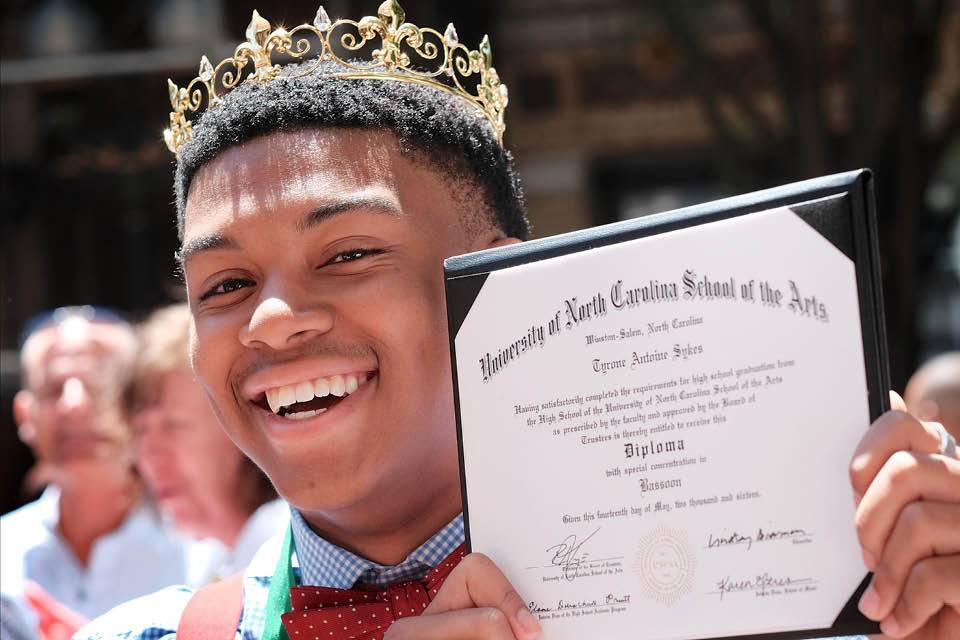 Tyrone Sykes shows off his diploma