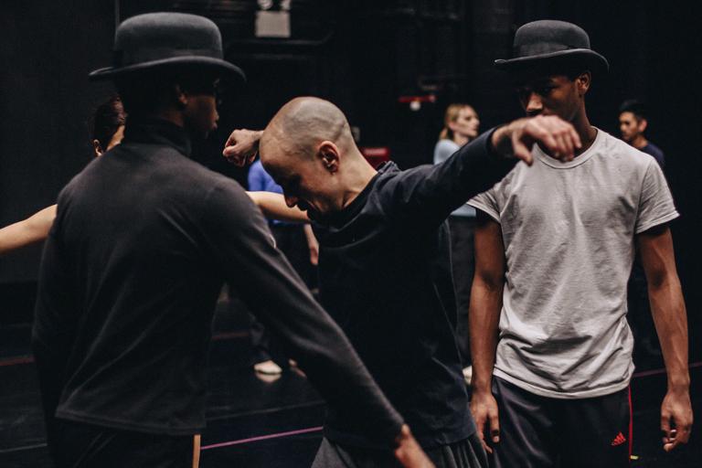 LeLan Lewis and Alban Costello look on as Goyo Montero demonstrates a step.
