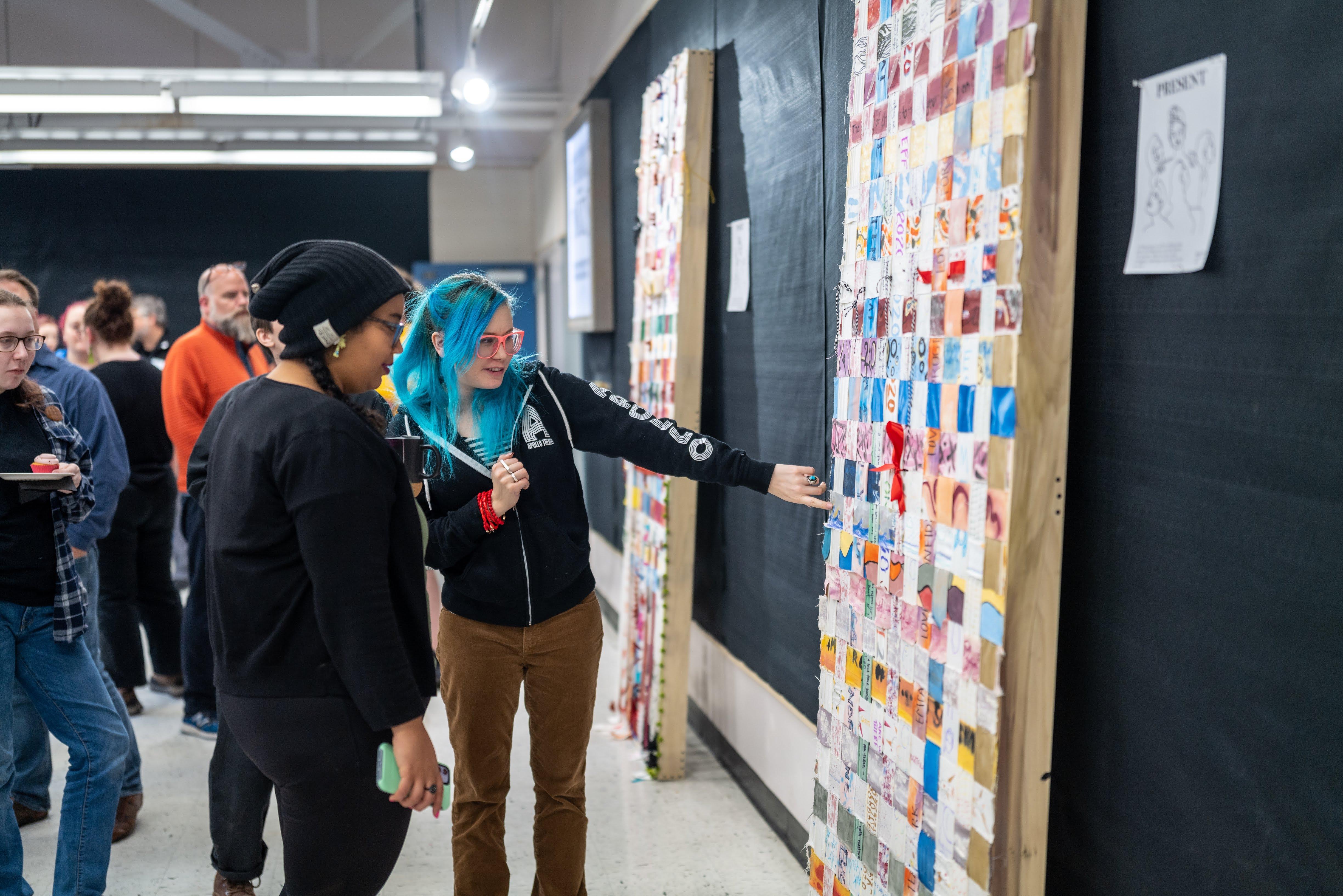 Speakers Christina Benvegnu and Karen Walcott view the "Present" art project. / Photo: Raunak Kapoor