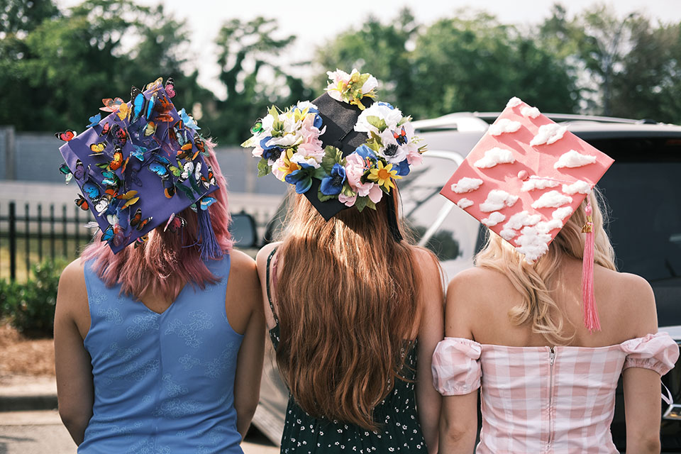 High School graduates display their creatively decorated caps at the High School Commencement ceremony. / Photo: Wayne Reich