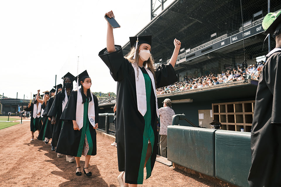 Graduates triumphantly enter Truist Stadium for High School Commencement. / Photo: Wayne Reich