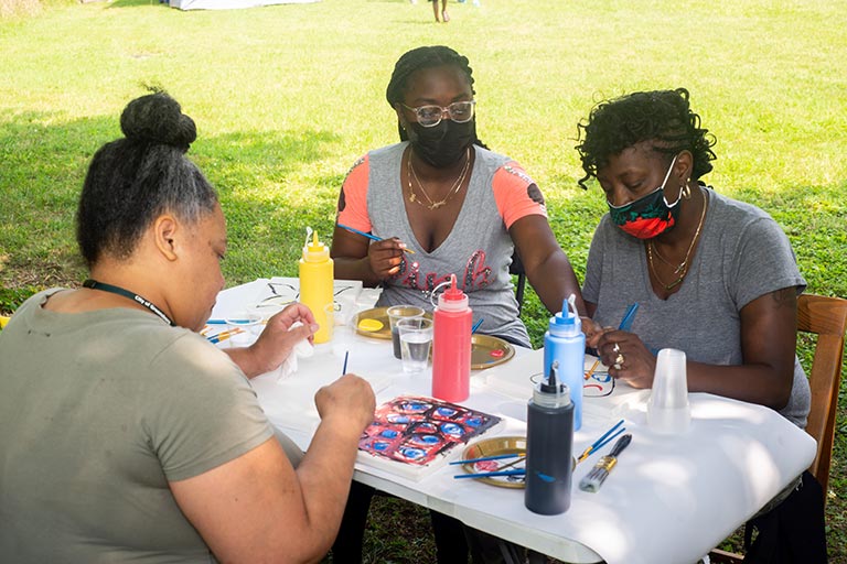 Artists with the Neighborhood Arts Residency Program host a community art event in the Kings Forest neighborhood.