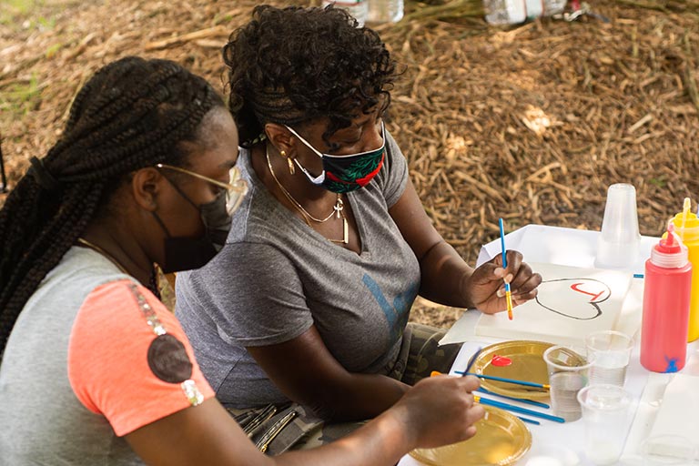 Artists with the Neighborhood Arts Residency Program host a community art event in the Kings Forest neighborhood.