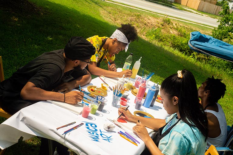 Artists with the Neighborhood Arts Residency Program host a community art event in the Kings Forest neighborhood.