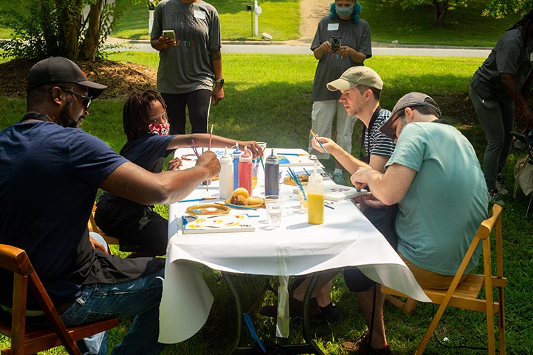 Artists with the Neighborhood Arts Residency Program host a community art event in the Kings Forest neighborhood.