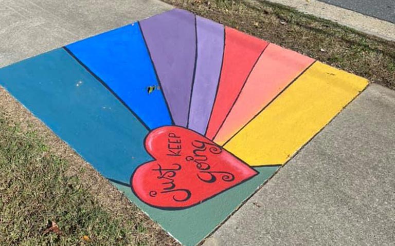 Murals painted on sidewalks, benches and picnic tables in the Kings Forest neighborhood in November 2021. / Photos: Ryan Deal