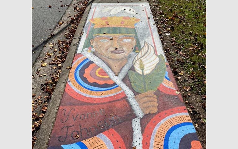 Murals painted on sidewalks, benches and picnic tables in the Kings Forest neighborhood in November 2021. / Photos: Ryan Deal
