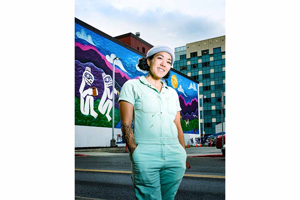 Artist Crystal Worl in front of mural. / Photo: Charles Tice