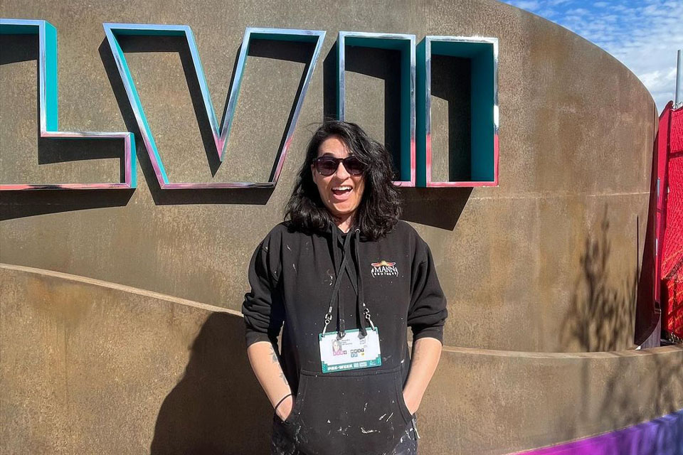 Design & Production Scene Painting alumnus Alexandra Finkel (B.F.A. ‘16) at the 2023 Super Bowl where she was a part of the team that painted the entrance of the State Farm Stadium.