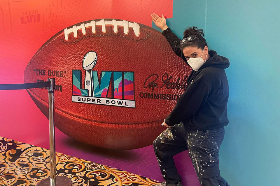 Design & Production Scene Painting alumnus Alexandra Finkel (B.F.A. ‘16) at the 2023 Super Bowl where she was a part of the team that painted the entrance of the State Farm Stadium.