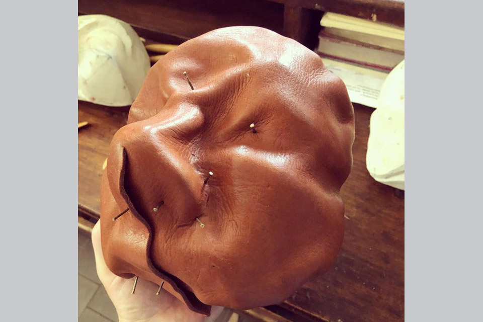 Molding the leather to the wood form. Photo Credit: Jason Bohon