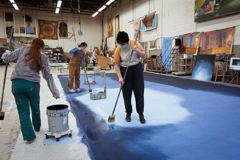 Scene Painting and Scenic Art students working on a drop for the 2024 A.J. Fletcher Opera Institute production "Maria di Rohan" / Rugile Zemaityte 