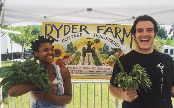 Ariel Blake and Matt Foley with some scrumptious greens at the farmer's market.