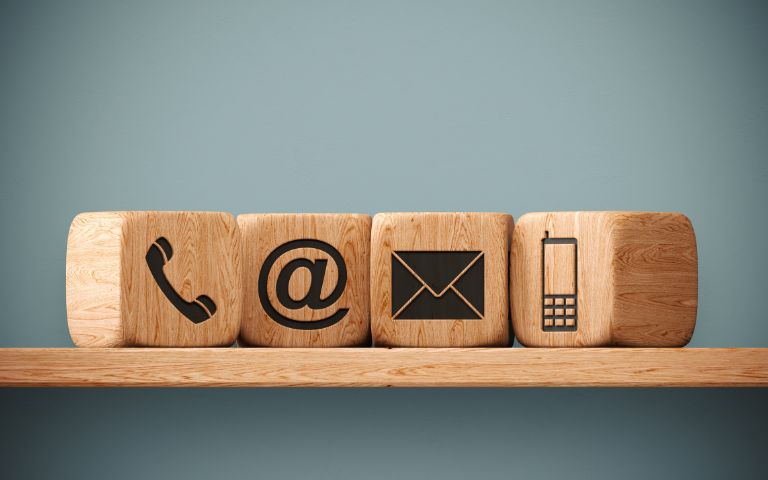Wooden cubes display contact icons. 