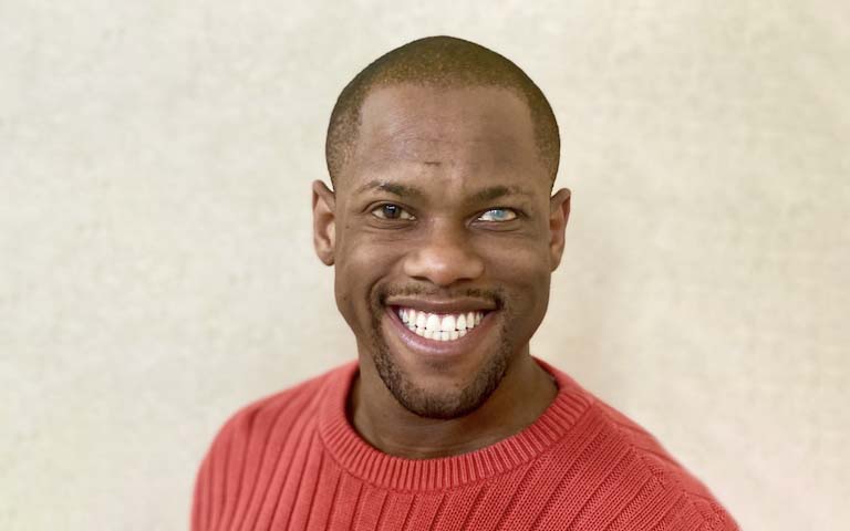 A photo of Davian Robinson smiling at the camera