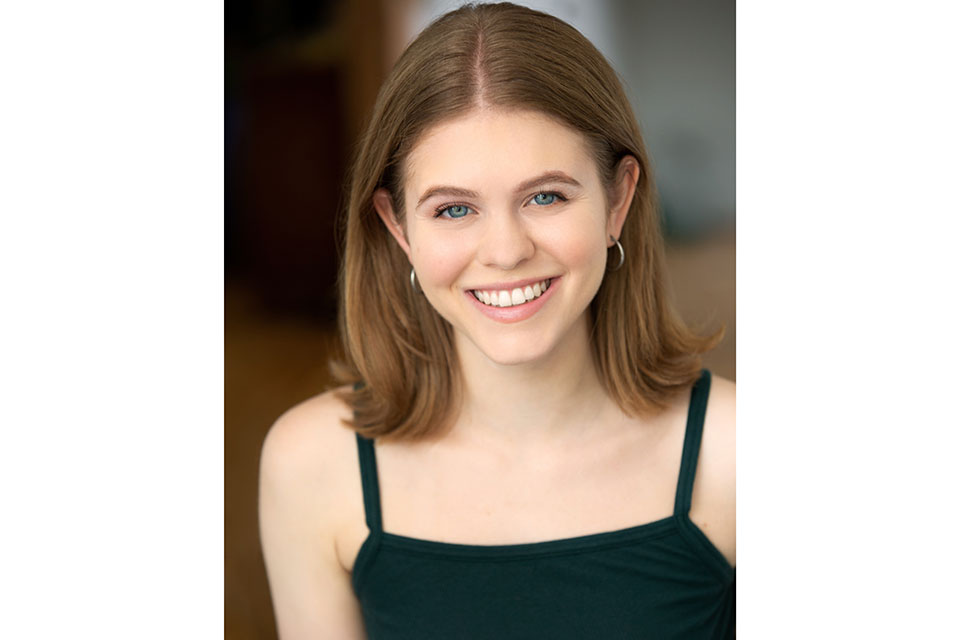 Noa Beckham-Chasnoff headshot, black tank top, smiling