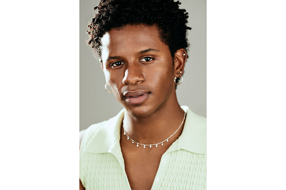 N'yomi Stewart headshot in green shirt