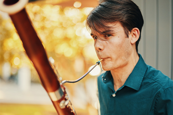 Music student playing an oboe