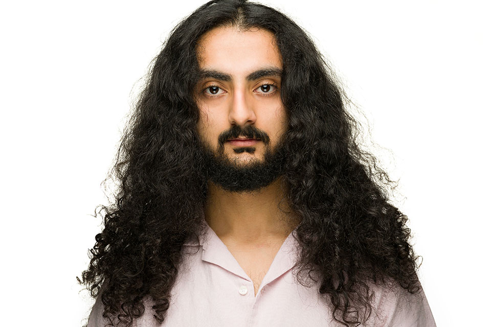 Headshot, hair falling over shoulders, on white background