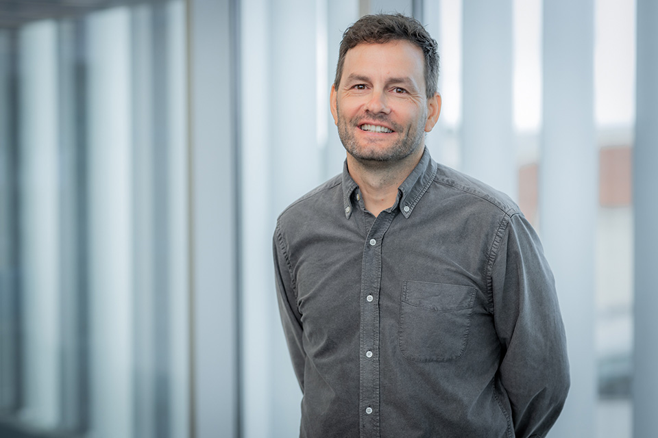 Andrew Brown poses in a button up shirt