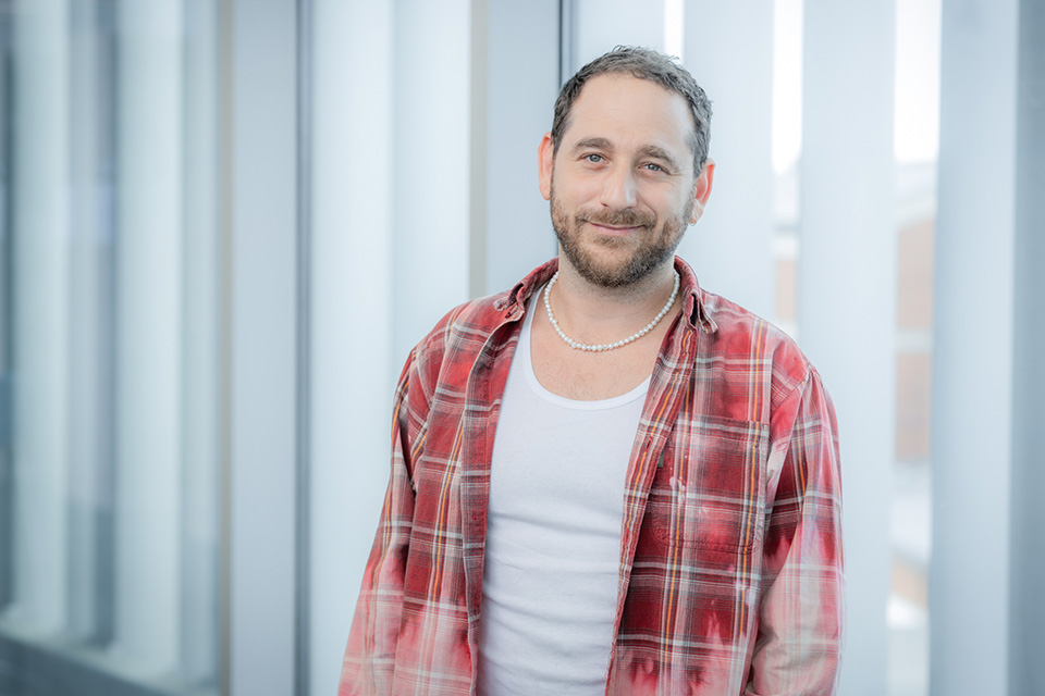 Eyal Resh posing in a flannel shirt
