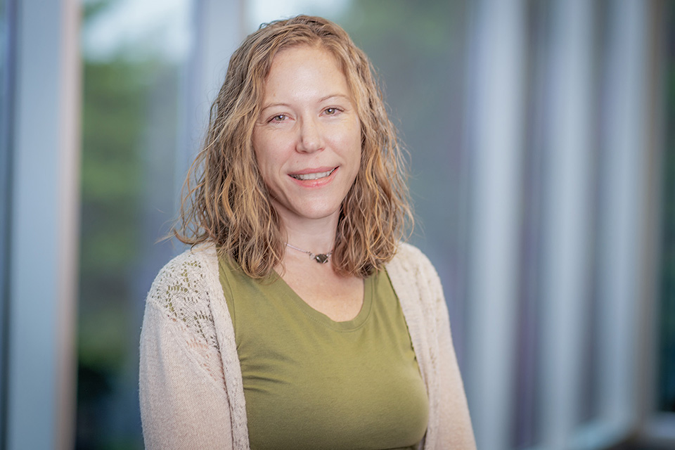 Michaela Colon poses in front of windows