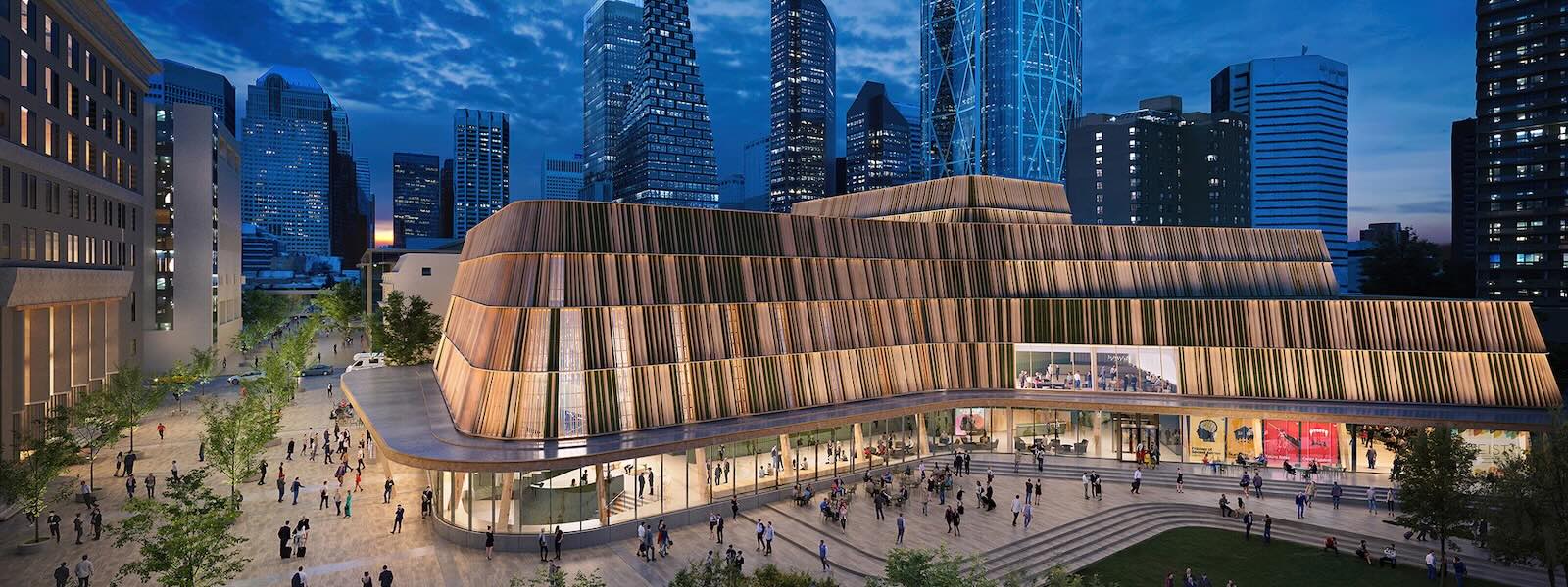 A architectural rendering shows a multi-story buillding at night nestled within a cityscape. The interior is brightly lit and people are standing and walking inside the lobby and outside in the plaza.