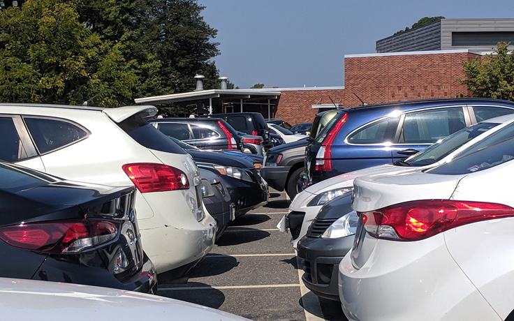 Many cars parked in a parking lot