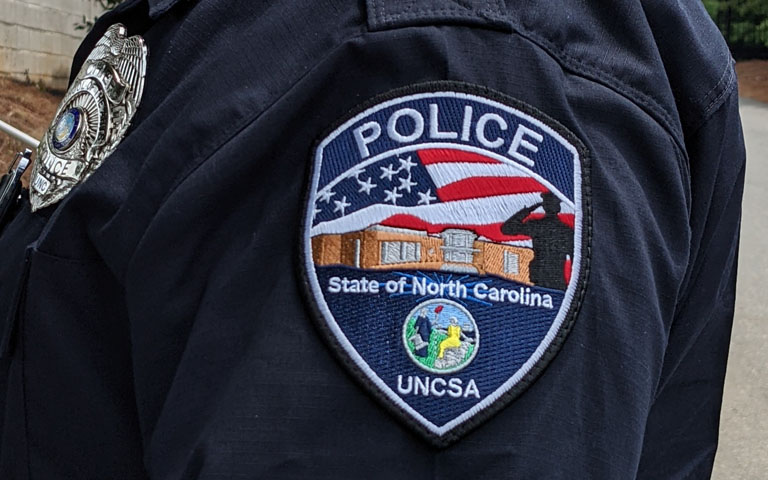 UNCSA police patch on a black sleeve of an officer.