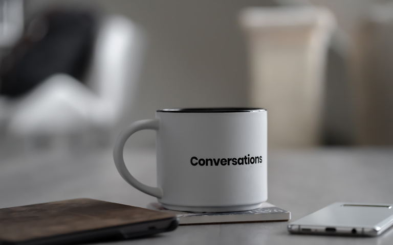 A coffee mug with the word conversations on it.