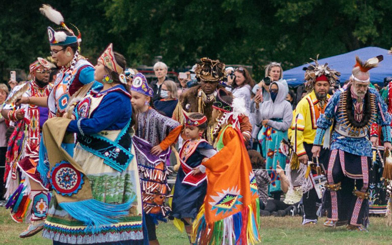 Indigenous communities living in North Carolina in tribal dress for the Dix Park Inter-Tribal Pow Wow.