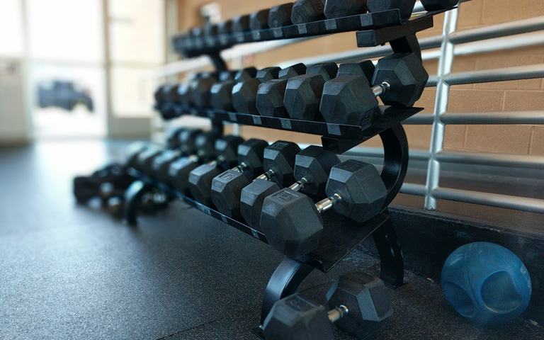 Hand weights on a rack