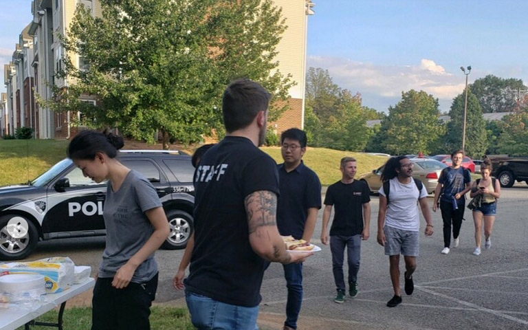 Students outside Center Stage line up for Cookout with a Cop