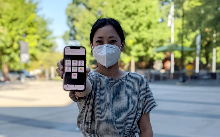 Female holding the safety app