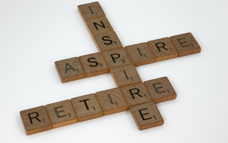 Scrabble tiles spell retire, inspire and aspire