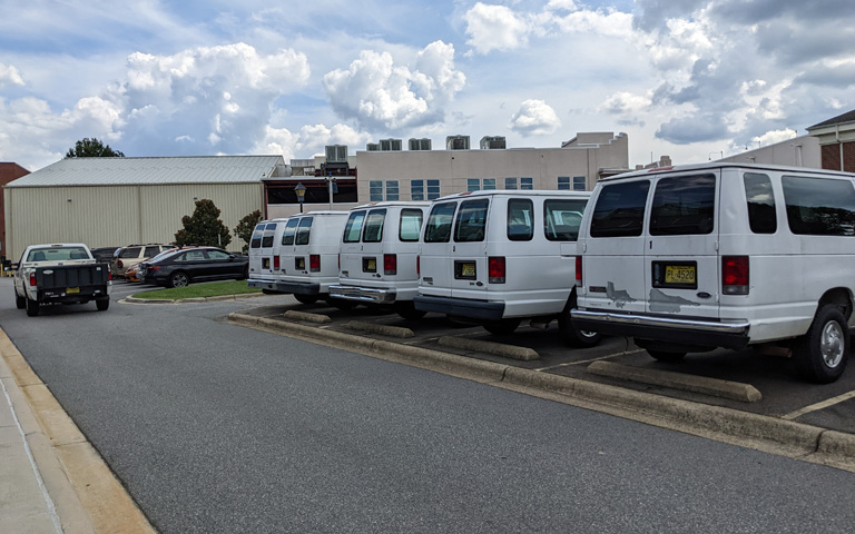 Row of UNCSA vehicle fleet in School of Filmmaking parking area
