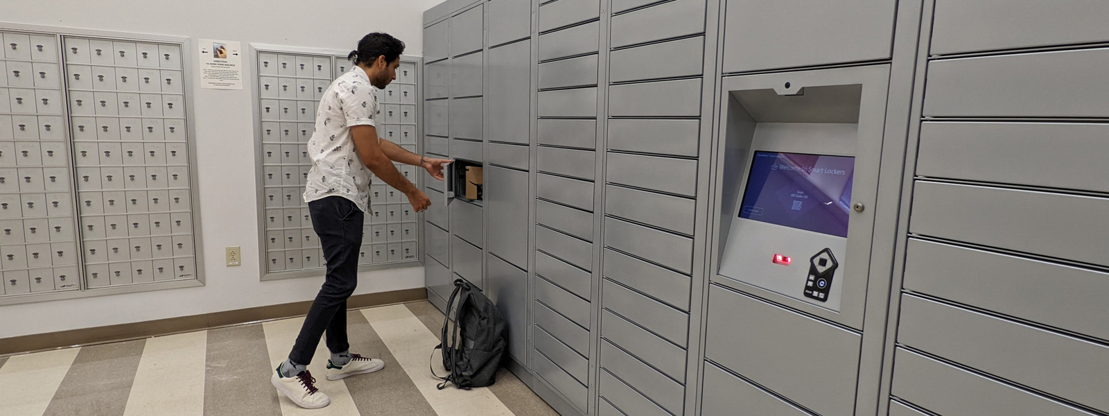 Student getting a package out of a mail locker.