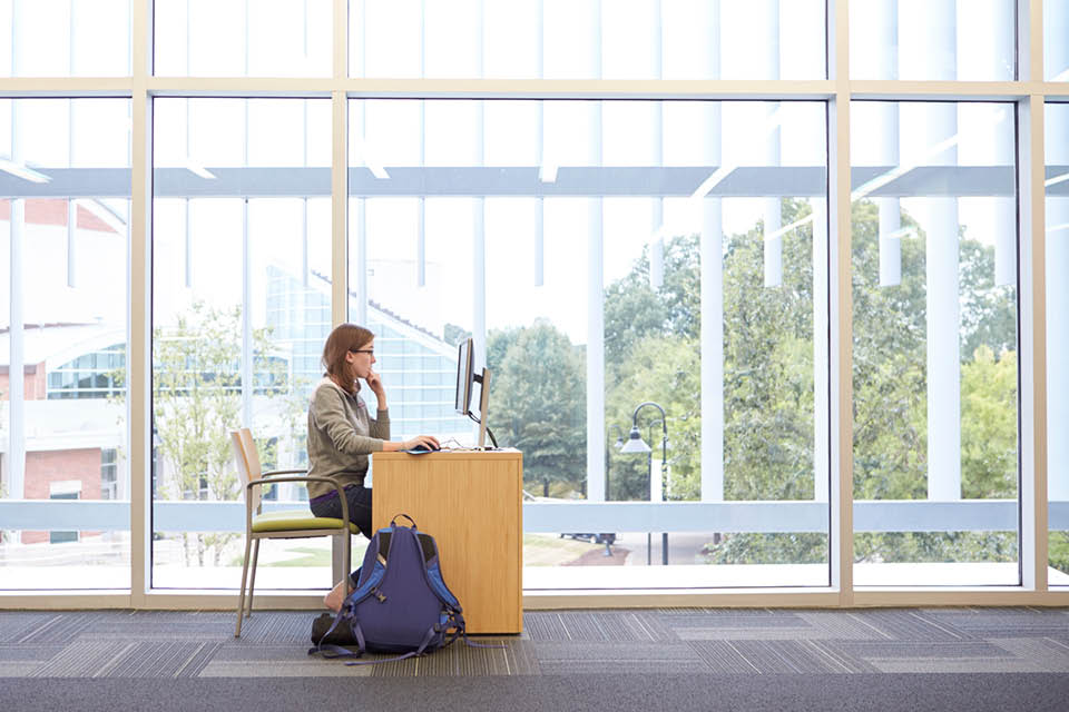 girl studies in library