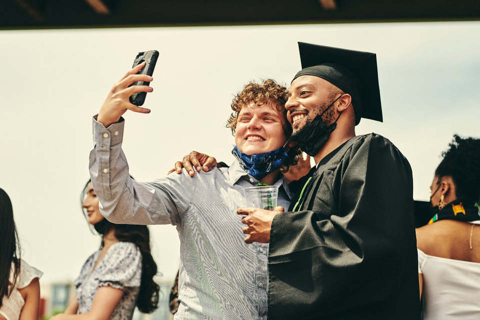 Sam Sherman and Lance Smith celebrate at University Commencement