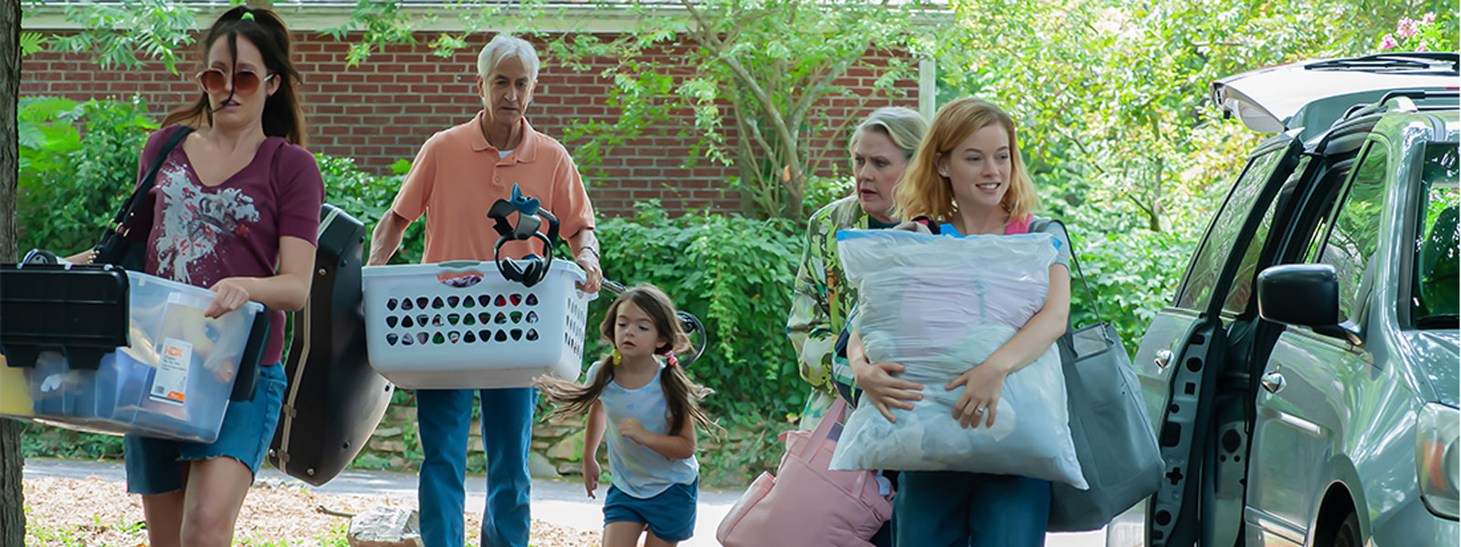 A family walks down the street, each carrying luggage, with a cheerful atmosphere surrounding them.