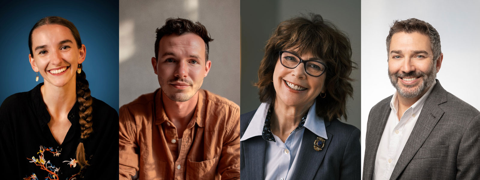 Four smiling individuals, one wearing glasses, pose together in a cheerful setting.