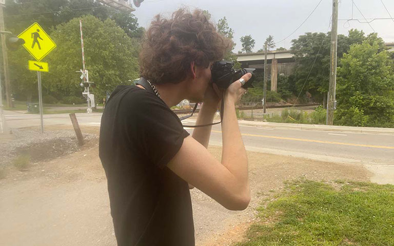 UNCSA Filmmaking student Emile Rizzo-Banks photographs the River Arts District in Asheville