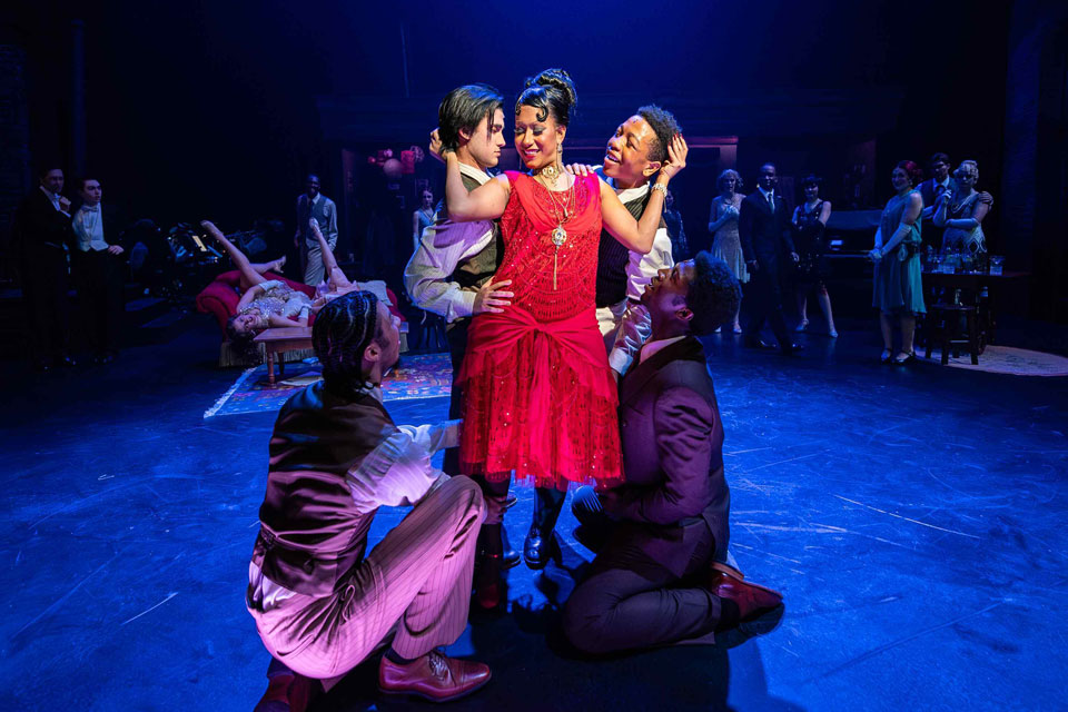 A group photo featuring colorful costumes and lively poses that capture the show's energy.