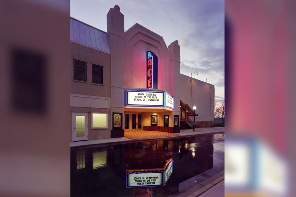 A movie theater exterior featuring a prominent sign and the building's exterior.