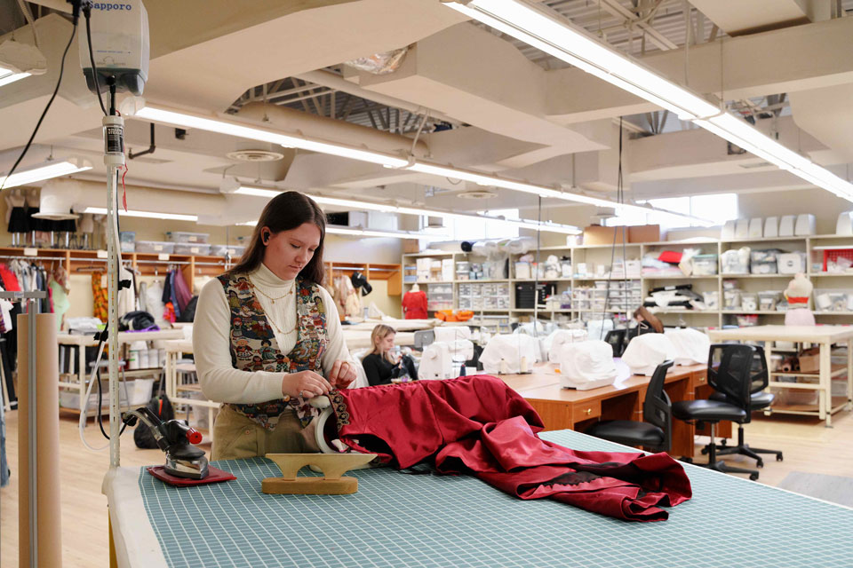 A woman sewing material