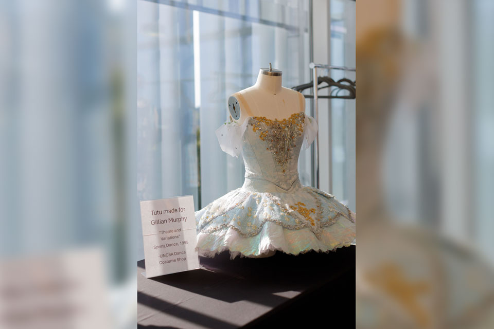 A stylish dress showcased in a bright room with a window, highlighting its design.