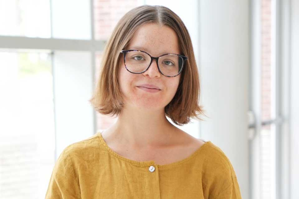 A young girl smiles at the camera.