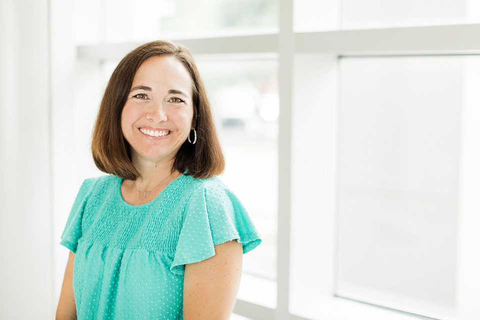 A woman smiling at the camera.