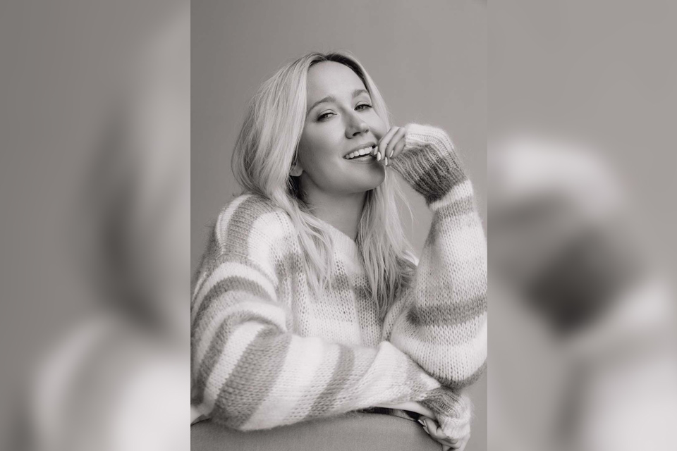 A woman smiling at the camera.