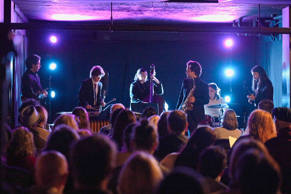 A group of musicians performs on stage.